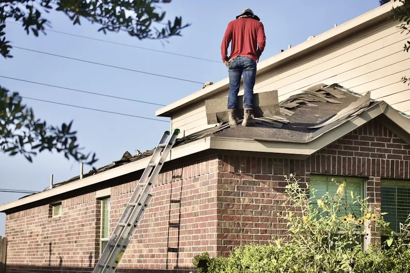 Professional roofer working on a residential roof in Grandview